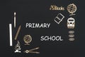 School supplies placed on black background with text primary school