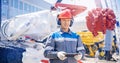 Concept banner smart industrial mining in mine. Miner in helmet with tablet computer on background of tunneling machine Royalty Free Stock Photo