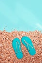 Concept of beach holiday. Sand Beach and and summer flip-flops with sunlight on abstract sea Royalty Free Stock Photo