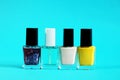 Concept of nail polish bottles, blue background, closeup Royalty Free Stock Photo