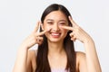 Concept of beauty, fashion and makeup products advertisement. Close-up portrait of carefree laughing, cute asian woman