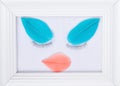 The concept of beauty : white photo frame decorated by the beauty of your eyelashes and feathers in mint and coral colors on a