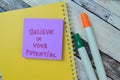 Concept of Believe in Your Potential write on sticky notes isolated on Wooden Table