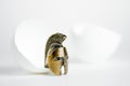 The concept of the birth of a warrior. Gladiator`s bronze helmet next to a broken egg shell Royalty Free Stock Photo
