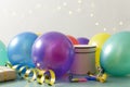 Concept of birthday party.Colorfil baloon, gifts on the table agaisnt bokeh lights