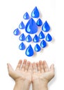 Concept blue water drop made of paper in two hands on white background. Royalty Free Stock Photo
