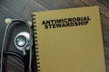 Concept of a book Antimicrobial Stewardship isolated on Wooden Table