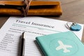 Concept booking travel insurance on wooden background