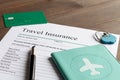 Concept booking travel insurance on wooden background