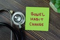 Concept of Bowel Habit Change write on sticky notes with stethoscope isolated on Wooden Table Royalty Free Stock Photo