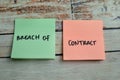 Concept of Breach of Contract write on sticky notes isolated on Wooden Table Royalty Free Stock Photo