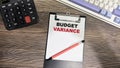 Concept of Budget Variance write on paperwork isolated on Wooden Table Royalty Free Stock Photo