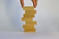 Concept of building success foundation. Men hand put wooden blocks on the stack of wooden blocks. Beautiful white background, copy