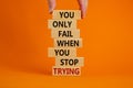 Concept of building success foundation. Men hand put wooden blocks on the stack of wooden blocks. Text `you only fail when you