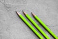 Concept of business, Back to school, three sharpened pencils on a background of gray plaster texture, space for text Royalty Free Stock Photo
