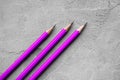 Concept of business, Back to school, three sharpened pencils on a background of gray plaster texture, space for text Royalty Free Stock Photo