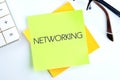 The concept of business and development. Conceptual text, phrase, word NETWORKING on the sticker on a light background