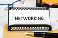 The concept of business and development. Conceptual text, phrase, word NETWORKING on a white business card on a stand