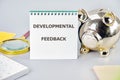 The concept of business and education. Conceptual word, phrase, text of the DEVELOPMENTAL FEEDBACK written in a notebook Royalty Free Stock Photo
