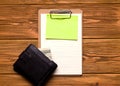 The concept of business and finance. Blank with a blank paper and a purse with money on a wooden table. Copy space. Royalty Free Stock Photo