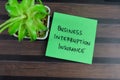 Concept of Business Interruption Insurance write on sticky notes on Wooden Table