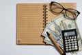 Concept of business, top view, calculator, pen, glasses, notebook written with tax on a white background. Copy space