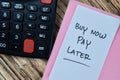 Concept of Buy Now Pay Later write on sticky notes isolated on Wooden Table Royalty Free Stock Photo