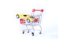 Concept of buying a new car. Toy car in shopping basket  on white background Royalty Free Stock Photo
