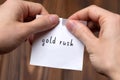 Hands tearing off paper with inscription gold rush