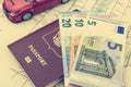 The concept of car travel: the passport and map. A few bills-Euro cash. Red car model. Soft processing in retro style Royalty Free Stock Photo