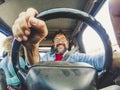 Concept of caucasian couple travel with car vehicle - inside wide view of man driver and woman passenger - happy people move with