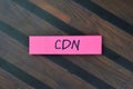 Concept of CDN - Content Delivery Network write on sticky notes isolated on Wooden Table