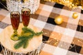 The concept of celebrating Christmas at home. Glasses with red wine on table under Christmas tree decorated with garland Royalty Free Stock Photo