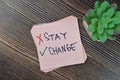 Concept of change and not to stay write on sticky notes isolated on Wooden Table Royalty Free Stock Photo