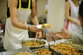 Concept charity for homeless with volunteers donating feeding free food