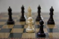 Two black and white pawns against 5 bishops on the chess board Royalty Free Stock Photo