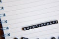 Concept of Chemotheraphy word on wooden cubes with books in background Royalty Free Stock Photo