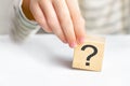 The concept of choice, decision making, solve a problem, find answer. Close-up hand of a child holding the question mark cube Royalty Free Stock Photo