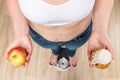 concept of choice and weight loss, a woman on scales with an apple Royalty Free Stock Photo