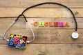 Concept cholera, heart stethoscope and colorful letters in metal box