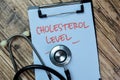 Concept of Cholesterol Level write on paperwork with stethoscope isolated on Wooden Table