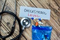 Concept of Cholesterol Level write on sticky notes with stethoscope isolated on Wooden Table