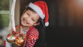 Concept of Christmas and child .The smiling girl stood behind the open door happily waiting to receive her Christmas presents Royalty Free Stock Photo