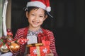 Concept of Christmas and child .The smiling girl stood behind the open door happily waiting to receive her Christmas presents Royalty Free Stock Photo