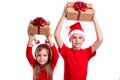 Concept: Christmas or Happy New Year holiday. Cheerful boy with santa hat on his head and a girl with deer horns