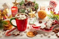 Concept Christmas homemade food and drink. Hot chocolate with marshmallows and cinnamon in red cup, Christmas cookies, winter