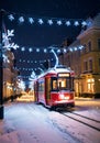 Christmas Lights On A City Tram, Passing Through A Snowy Street At Night. Generative AI