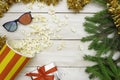 The concept of cinema, New Year and Christmas. Popcorn spills out of the box, green Christmas tree branches and 3D glasses. Light Royalty Free Stock Photo