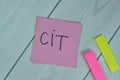 Concept of CIT - Corporate Income Tax write on sticky notes isolated on Wooden Table