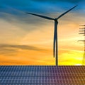 Concept clean energy. wind turbine and solar panel in sunset background. Royalty Free Stock Photo